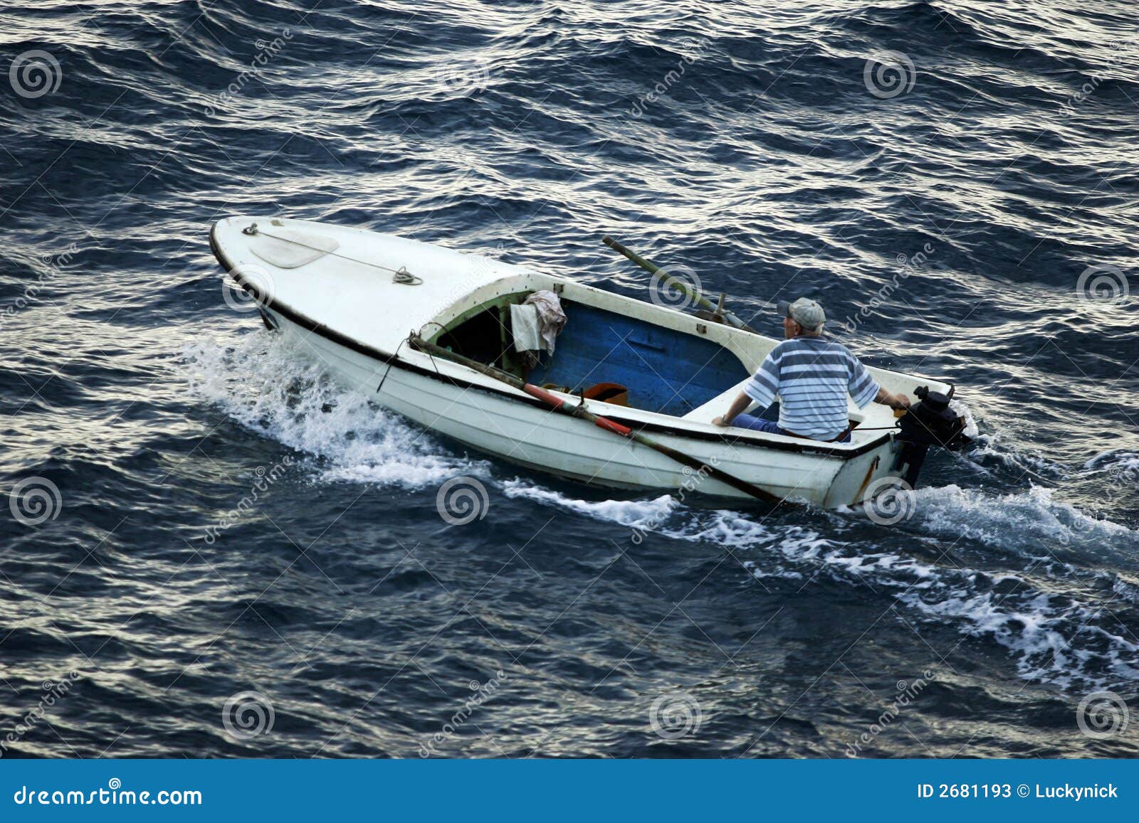 Man in small motorboat stock image. Image of water 