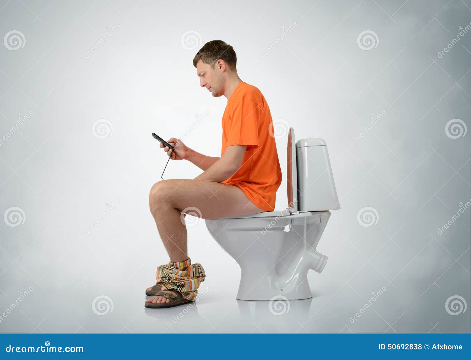 man-smartphone-sitting-toilet-background-50692838.jpg