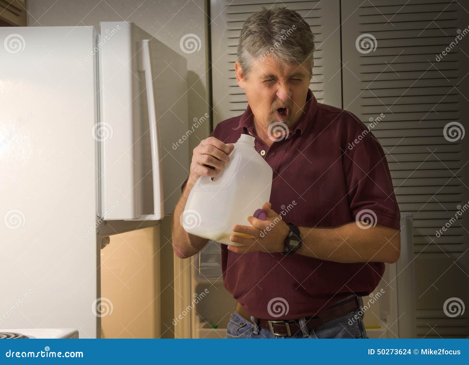 man smelling spoiled rotten sour milk
