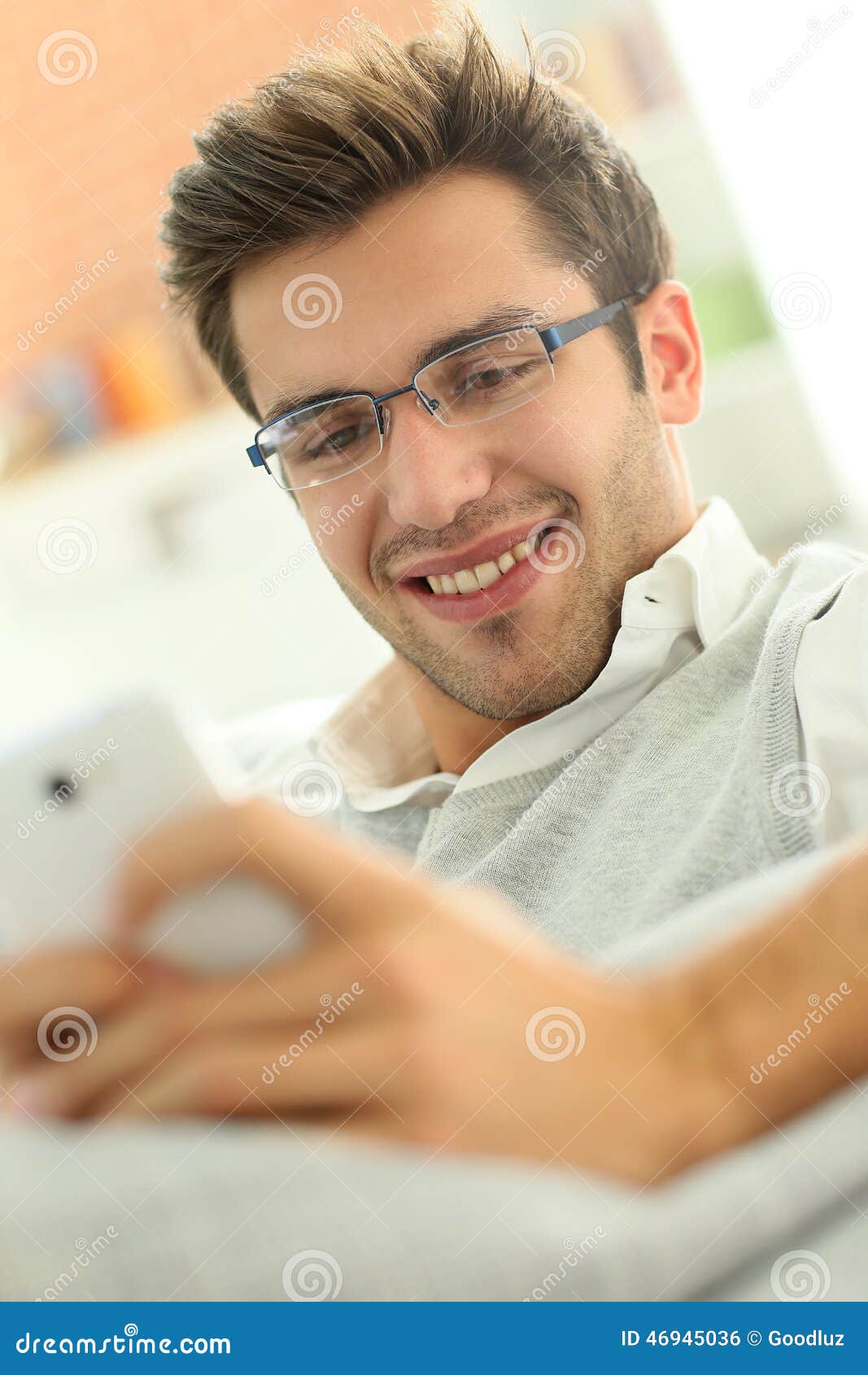 Man in Sofa Using Smartphone Stock Photo Image of portrait, cheerful