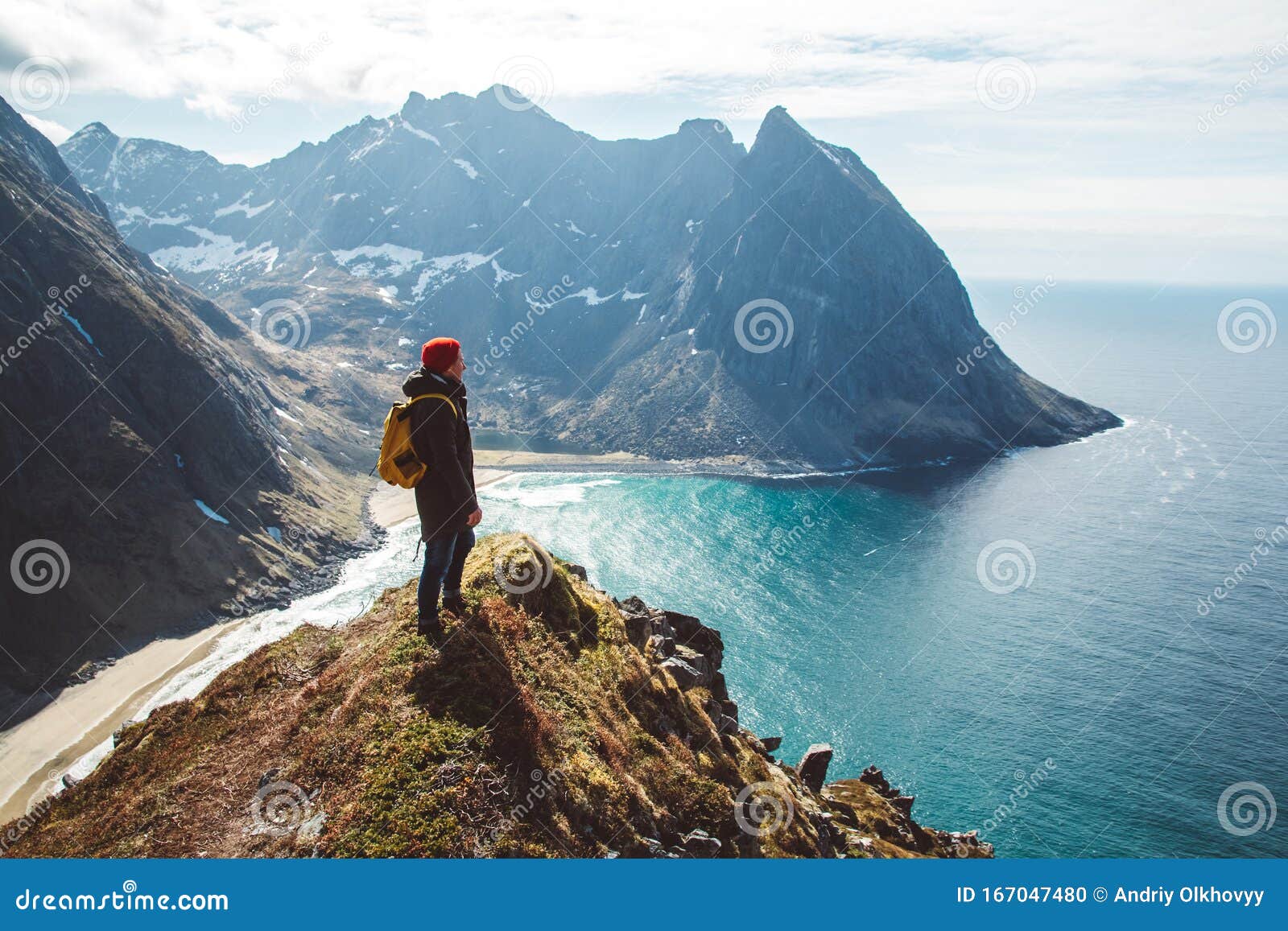 man stand on cliff edge alone enjoying aerial view backpacking lifestyle travel adventure outdoor vacations