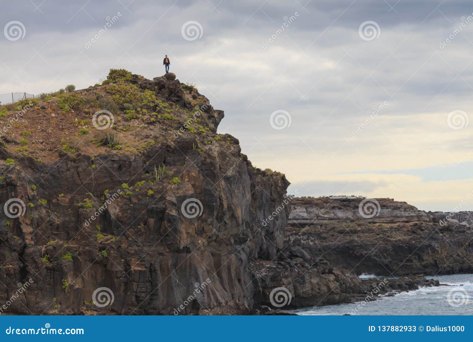 man standing on the edge of cliff callo salvaje, tenerife canary islands