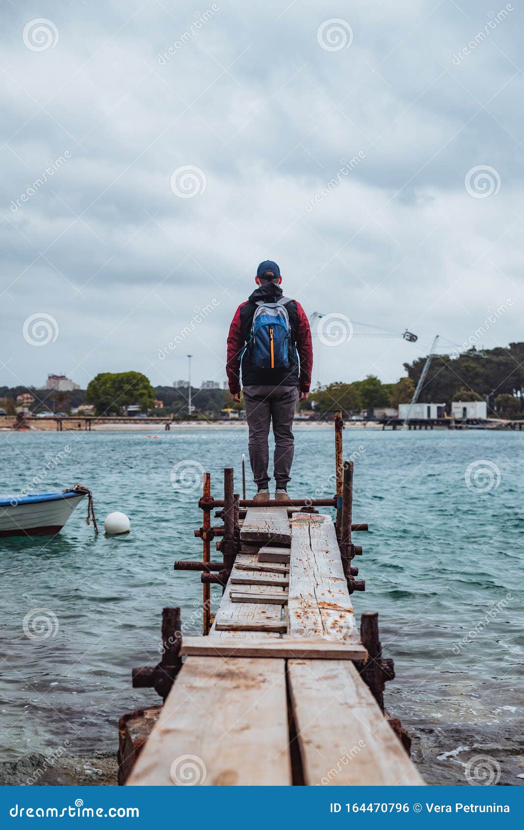 Man Standing at Edge of the Small Fishing Pier Looking at Stormy Sea Stock  Photo - Image of storm, outdoor: 164470796