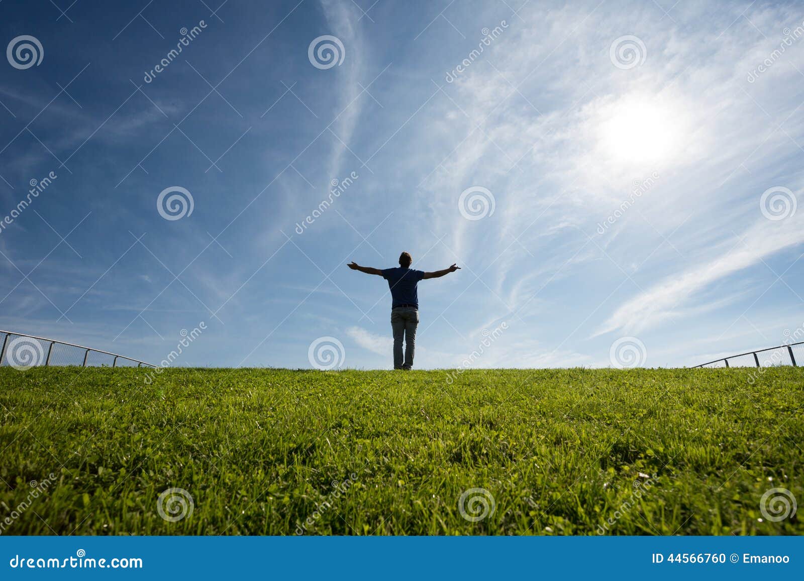 man standing on grass in sunlight