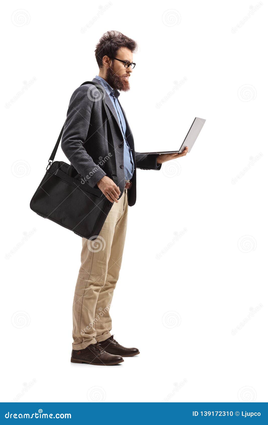 Man Standing with a Shoulder Bag and Holding a Laptop Stock Photo ...