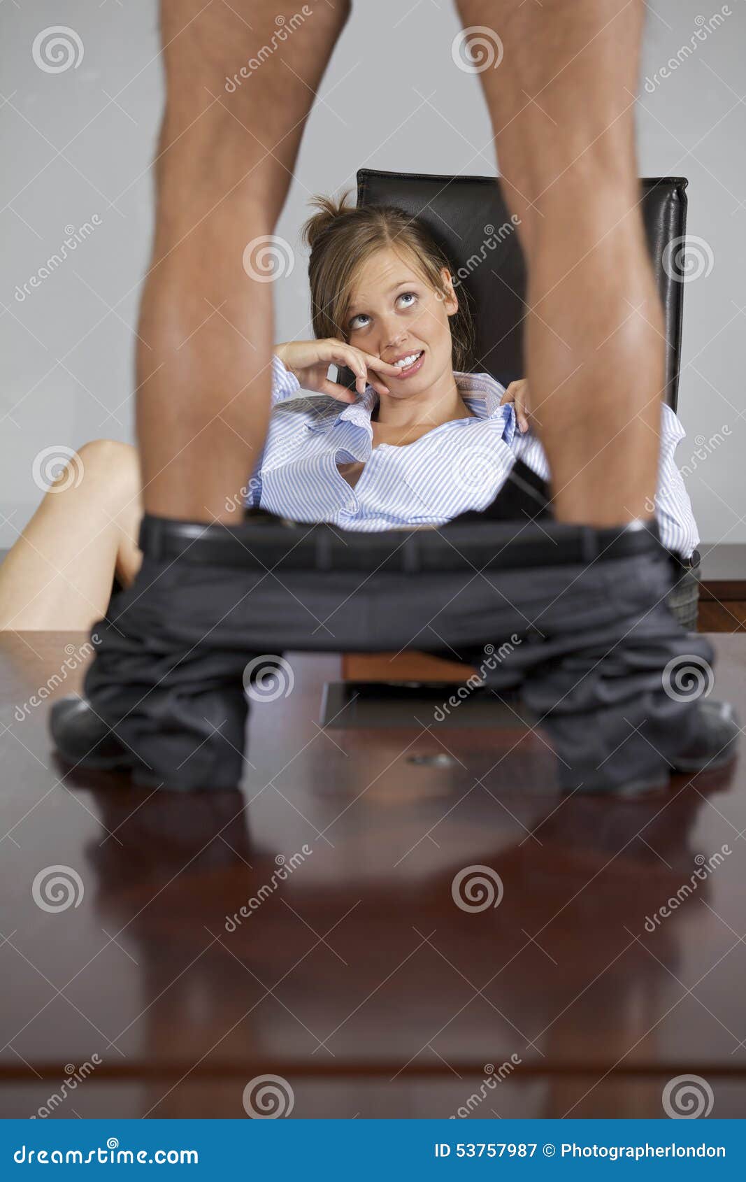man standing on table with trouser down, flirting with businesswoman in office
