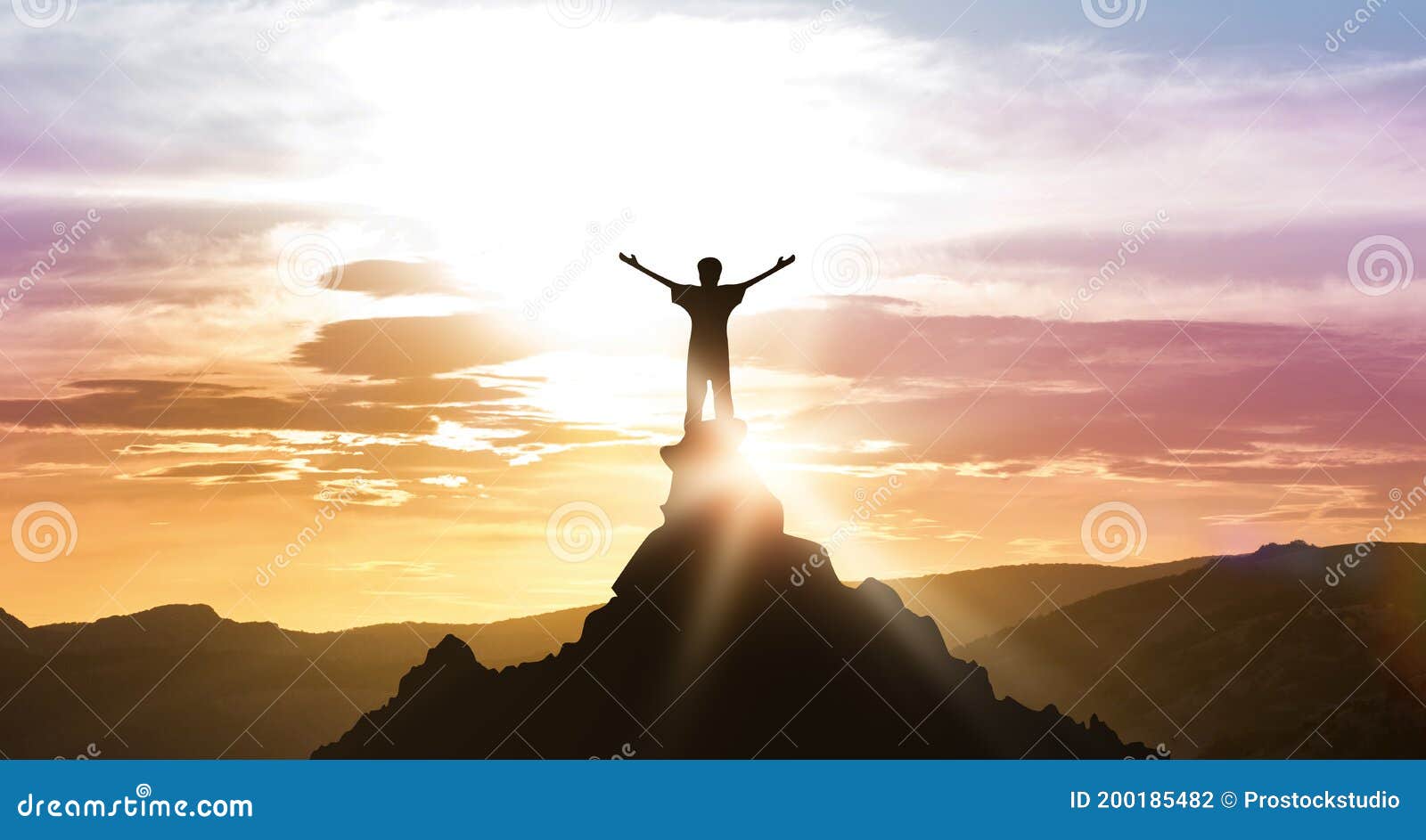 man standing on top of mountain looking at daybreak outdoors