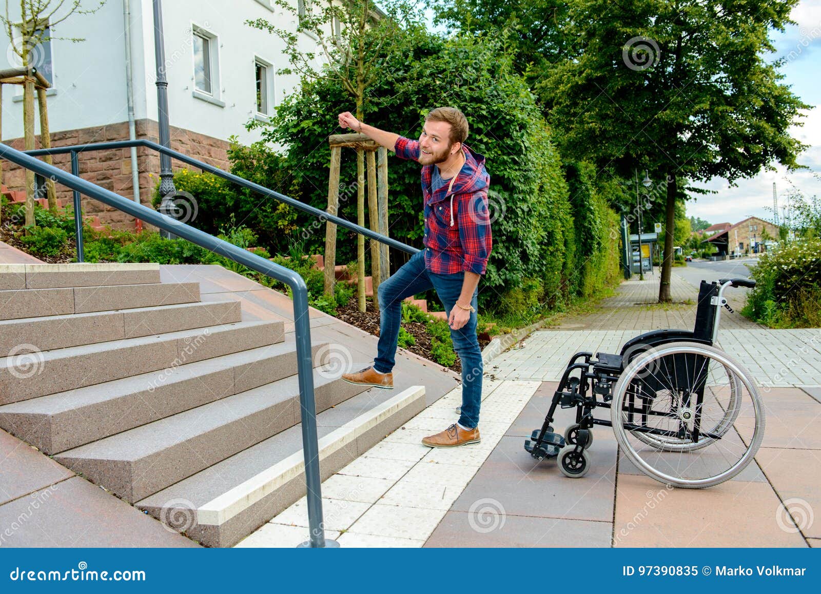 Man Standing With Wheelchair In Front Of Stairs RoyaltyFree Stock