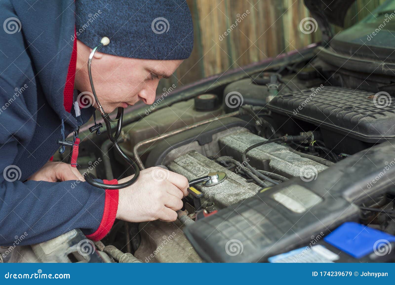 Man with Stethoscope Checking Car Engine, Auto Service Stock Image