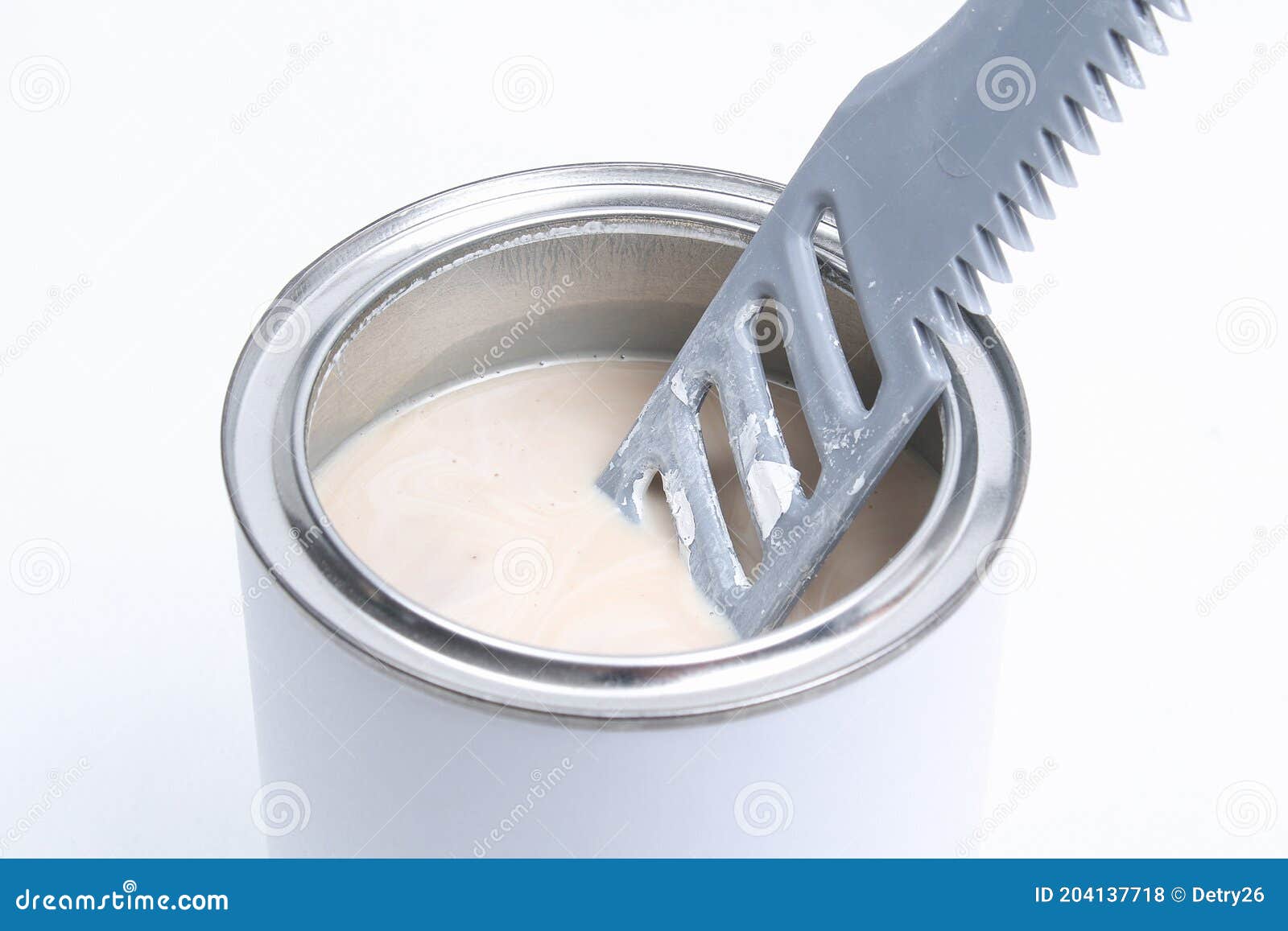 A Man Stirring White Paint in Can on White Background. Renovation