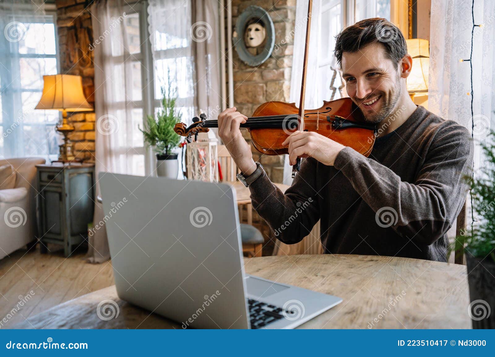 Man Student Learns To Play the Violin Online Laptop. Stock Image - Image instrument, 223510417