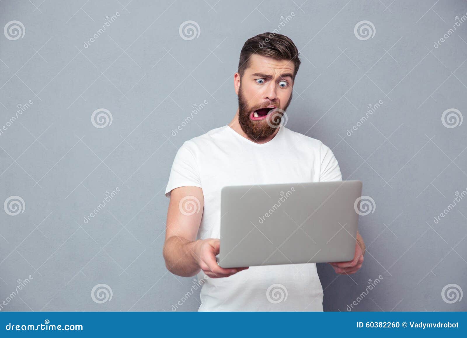 man with stupid mug using laptop