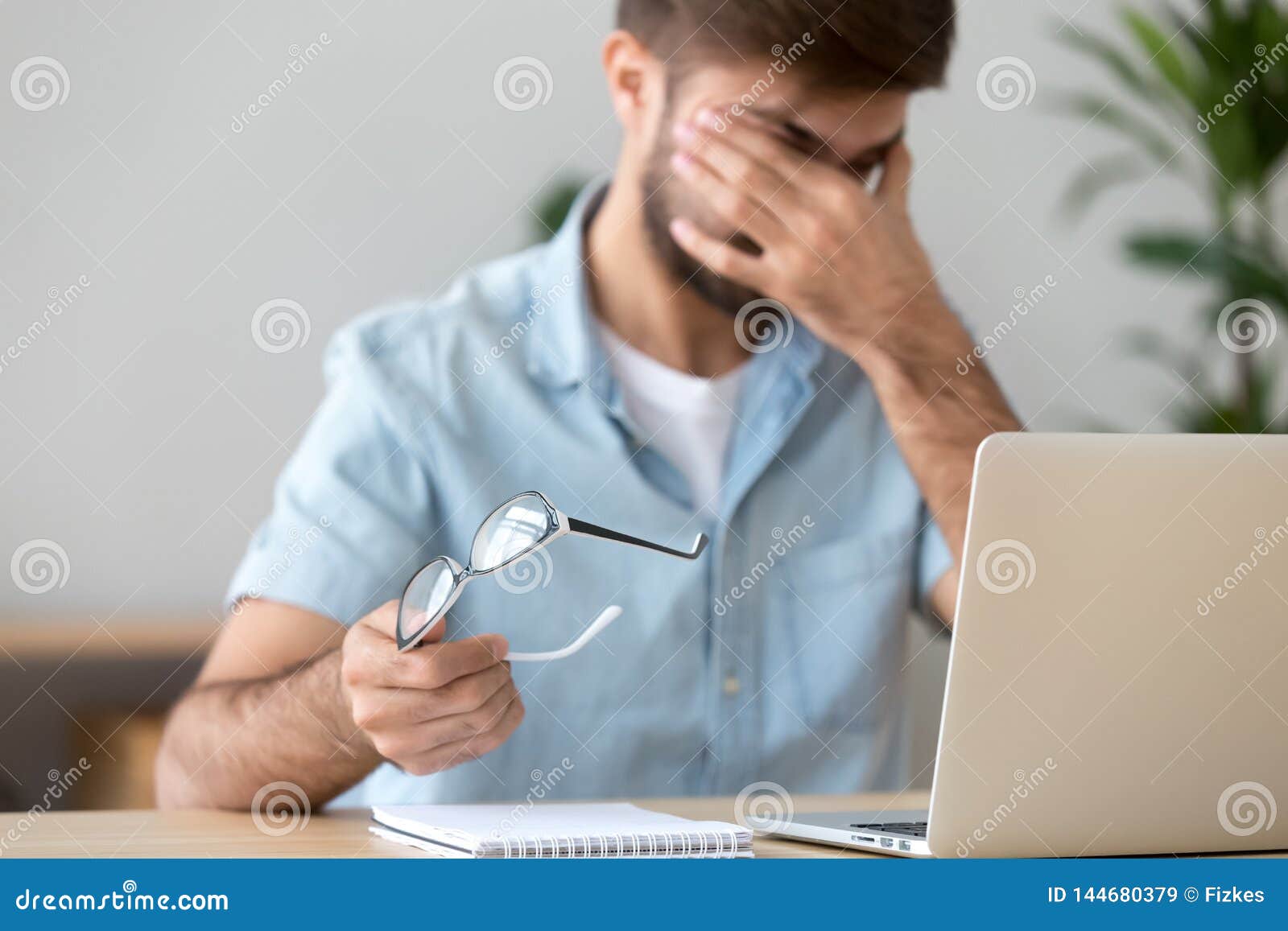man suffering from dry eyes syndrome after long computer work