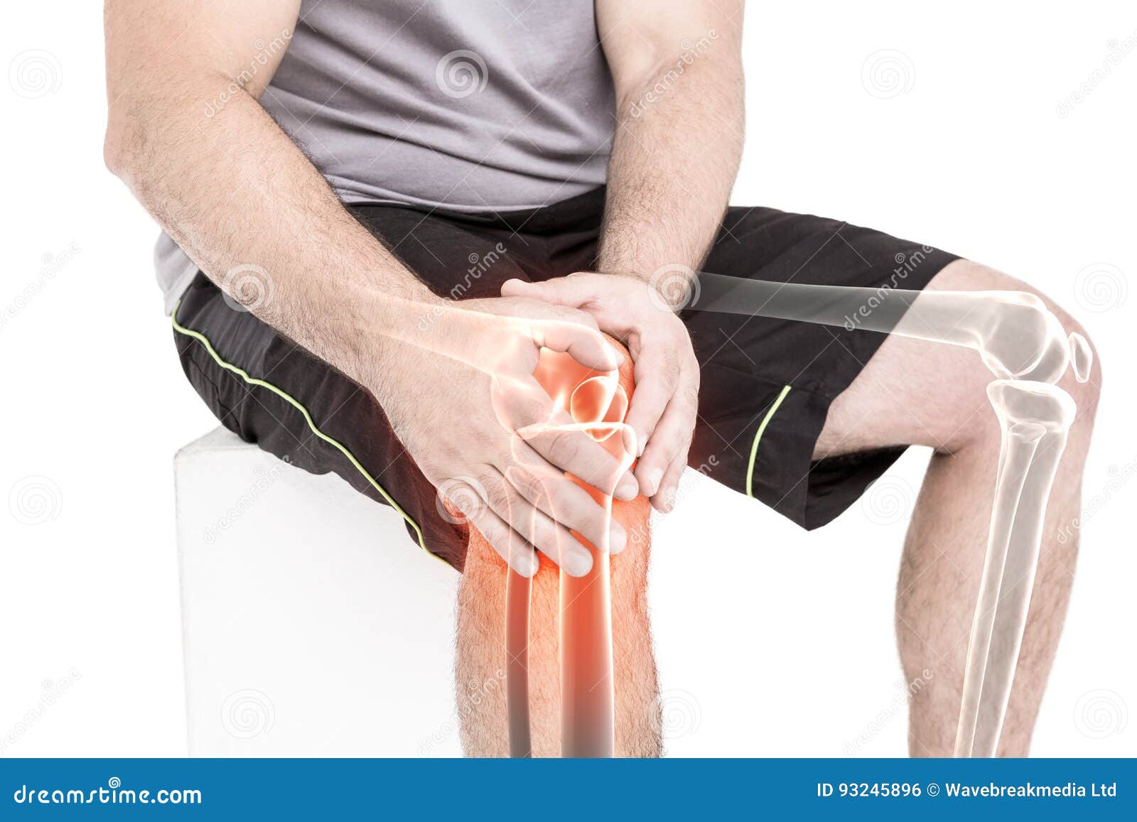 Man Suffering With Knee Pain While Sitting Against White Background