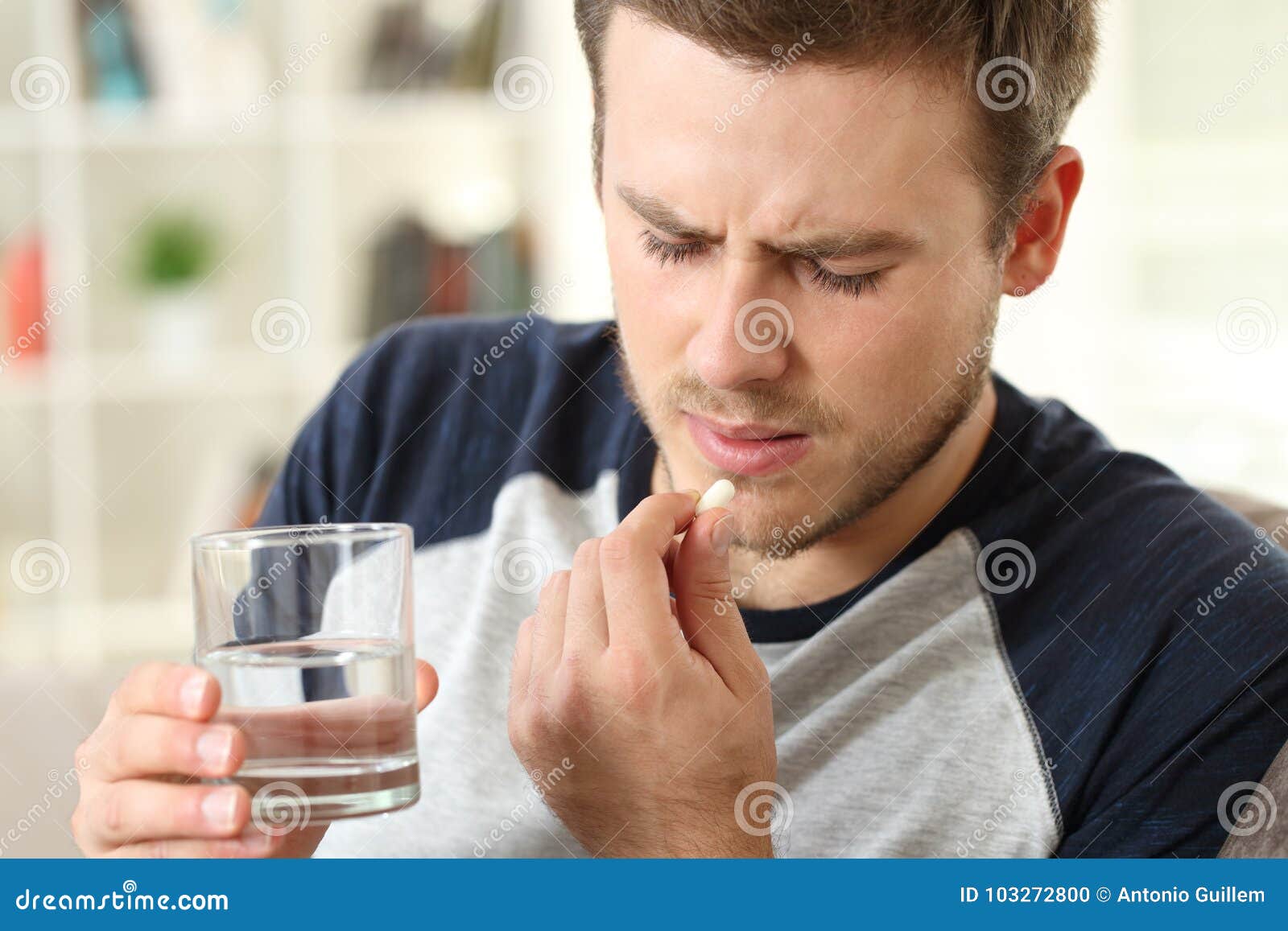 man suffering taking a pill
