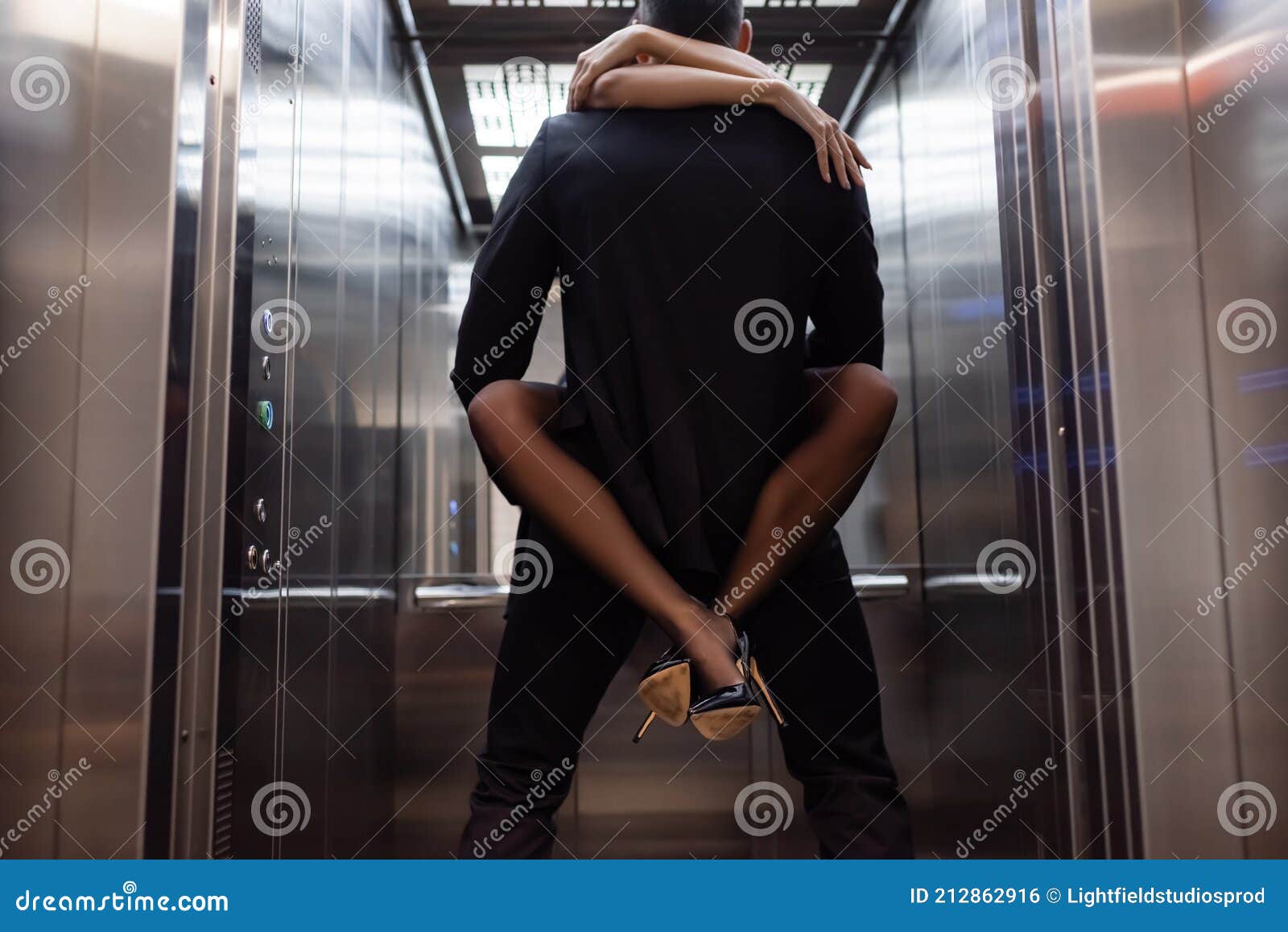 Man in Suit Holding Girlfriend in Stock Photo Image of shoes, heels