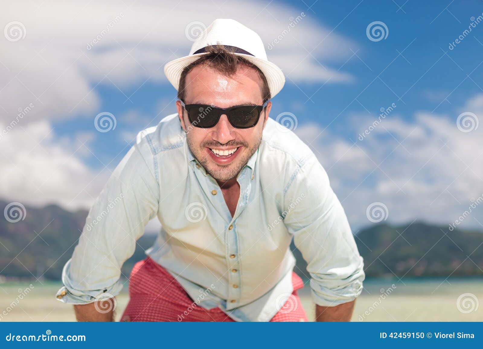 Man with Sunglasses and Hat Smiling on the Beach Stock Photo - Image of ...