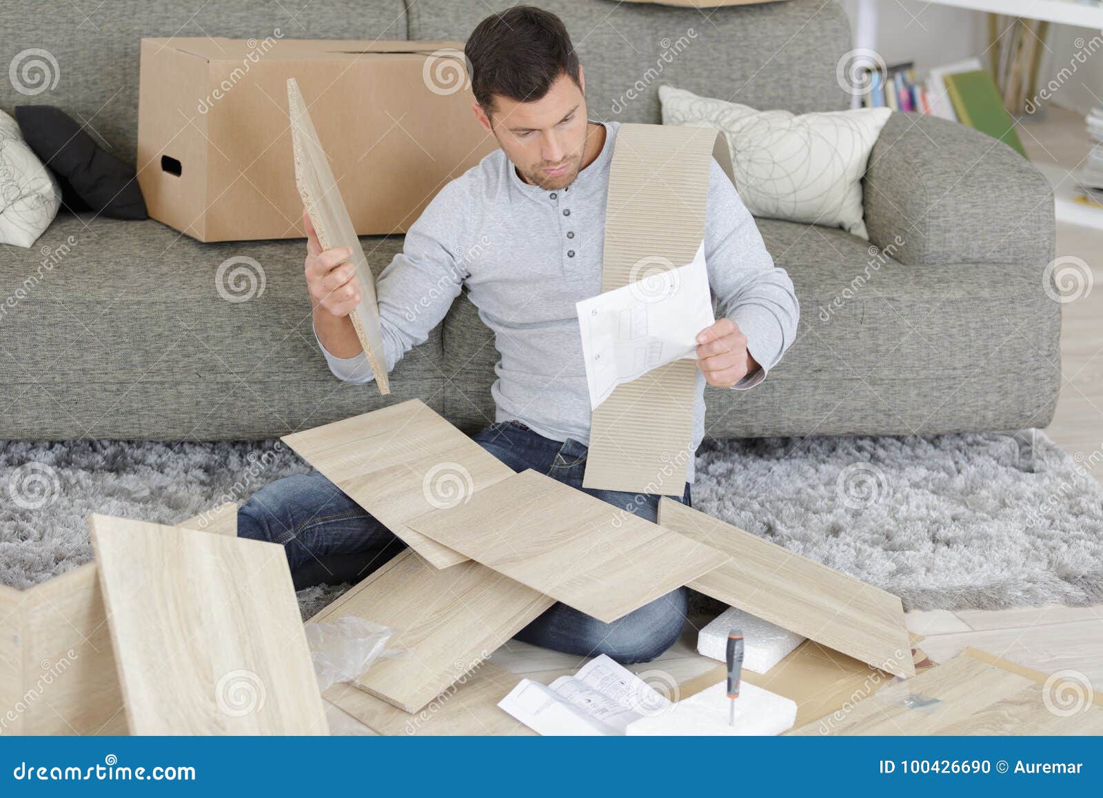 man surrounded by pieces flat pack furniture