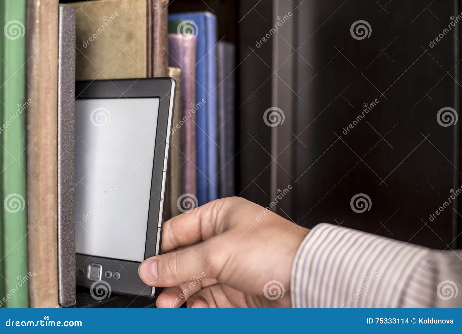 The Man Takes The E Book From A Bookshelf Stock Photo Image Of