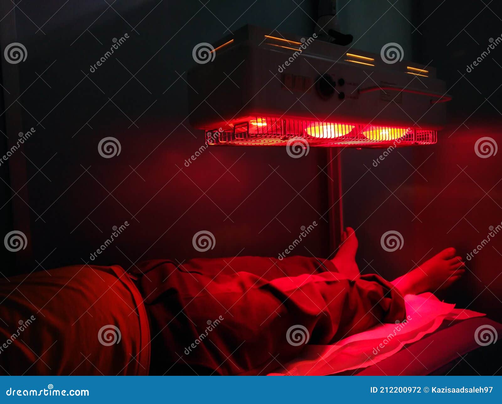 A Man Taking Low Level Laser Therapy on His Leg Using Red Therapy Light