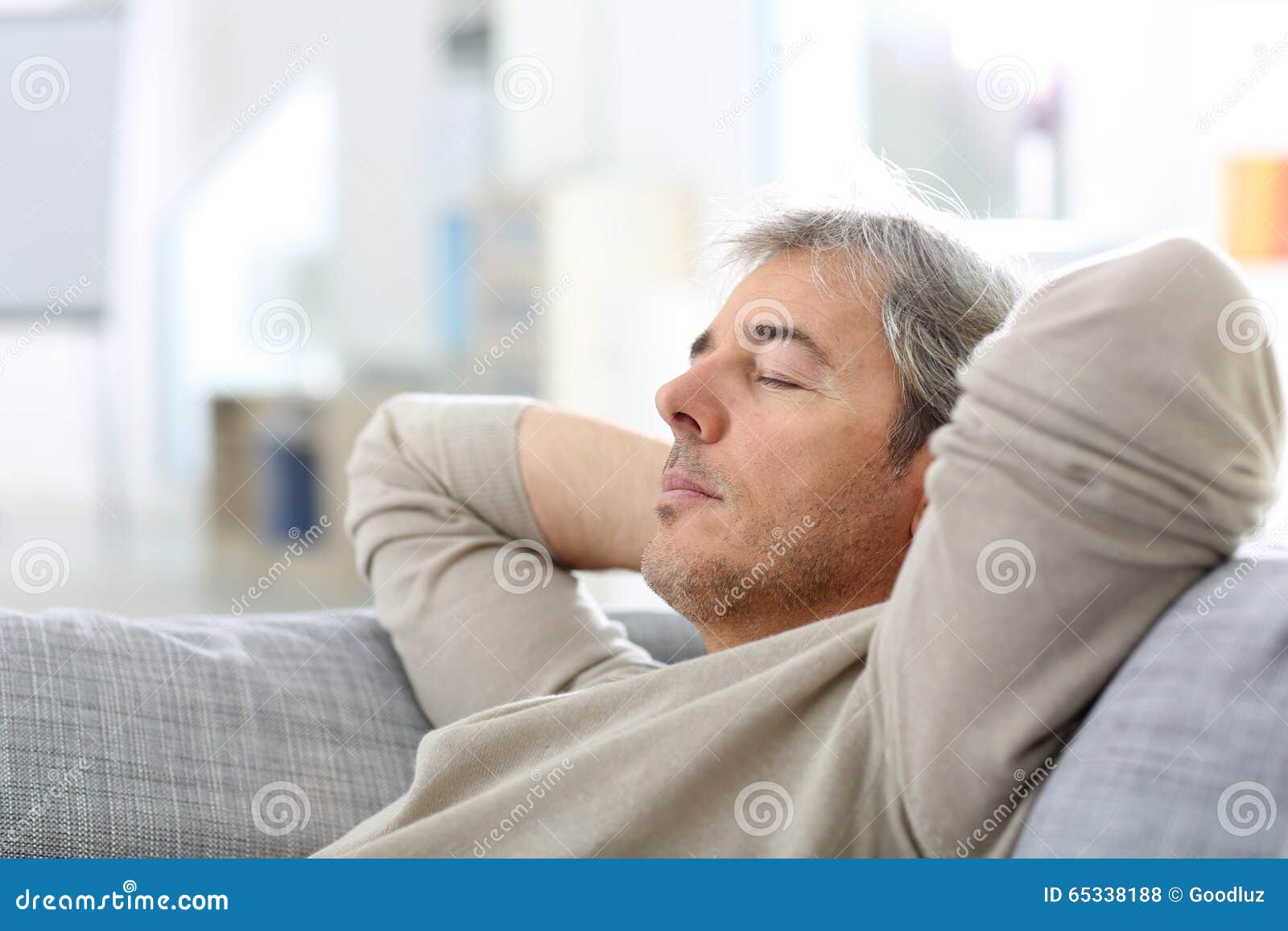 man taking a nap in sofa