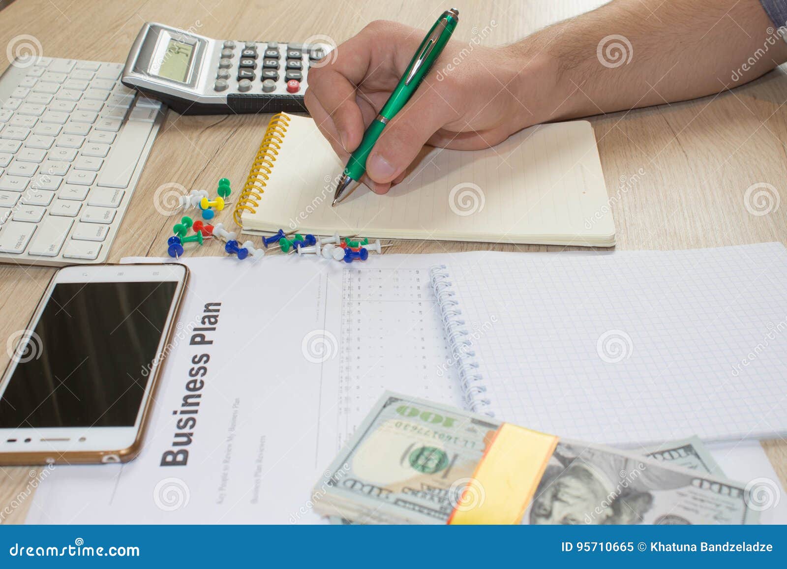 Man, Taking Notes. Man with Dollars, Cash on the Table. Profits