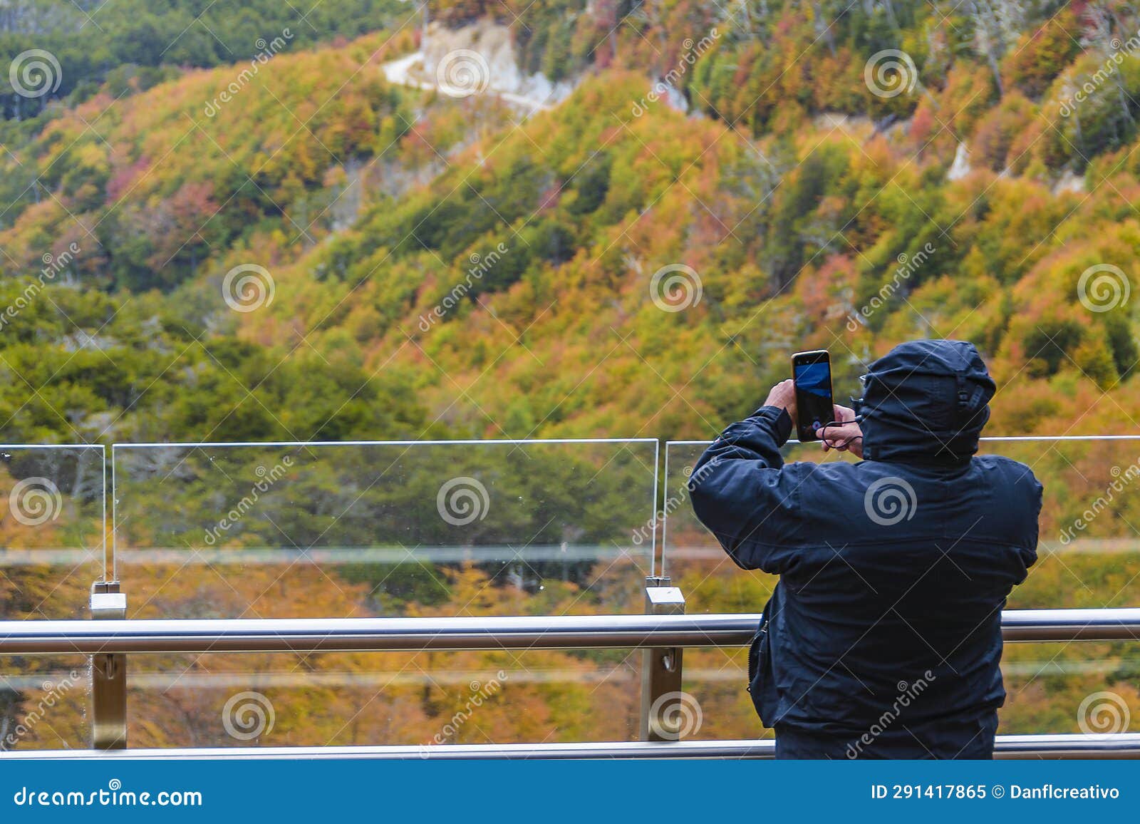man taking photos at mirador garibaldi, tierra del fuego, argentina