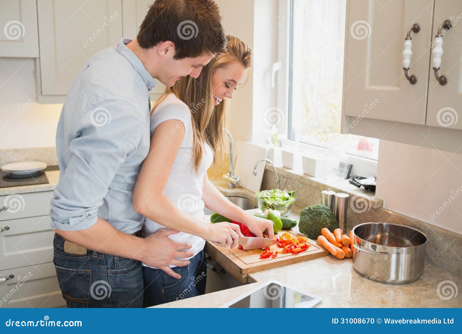 Man Talking with Woman while Cooking Stock Photo