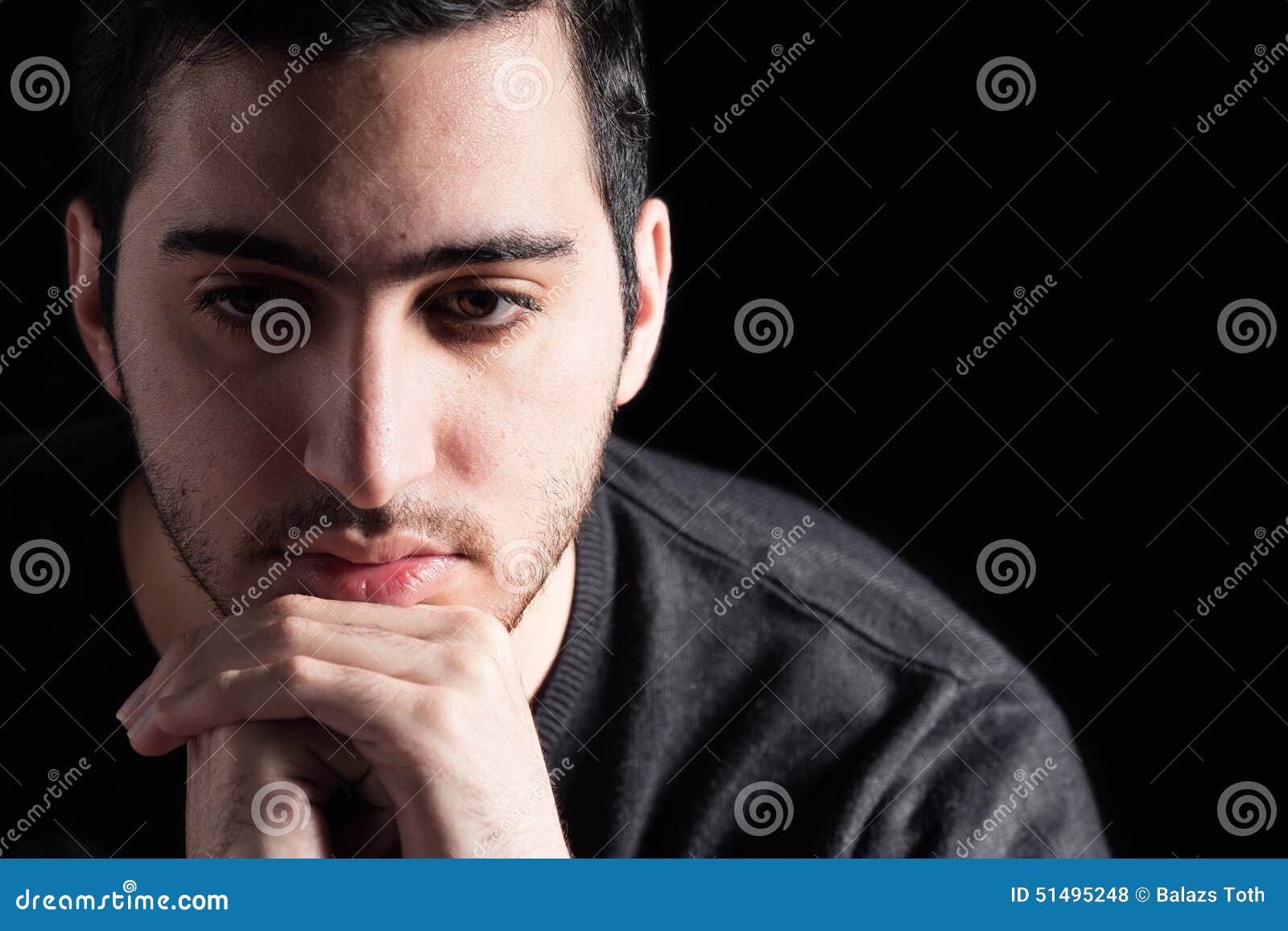 Man Thinking. Young Man on Black Background