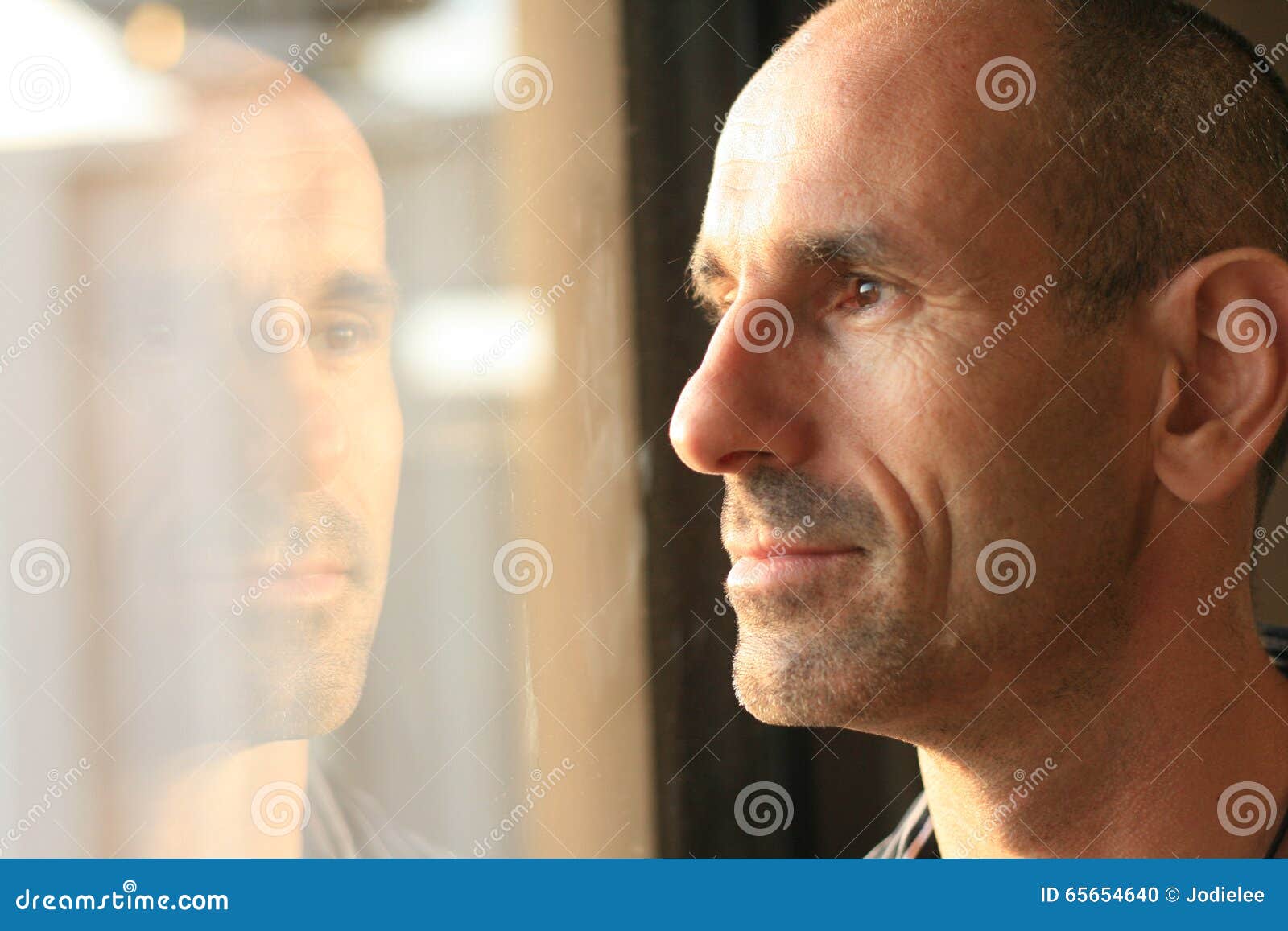 man in thought with window reflection