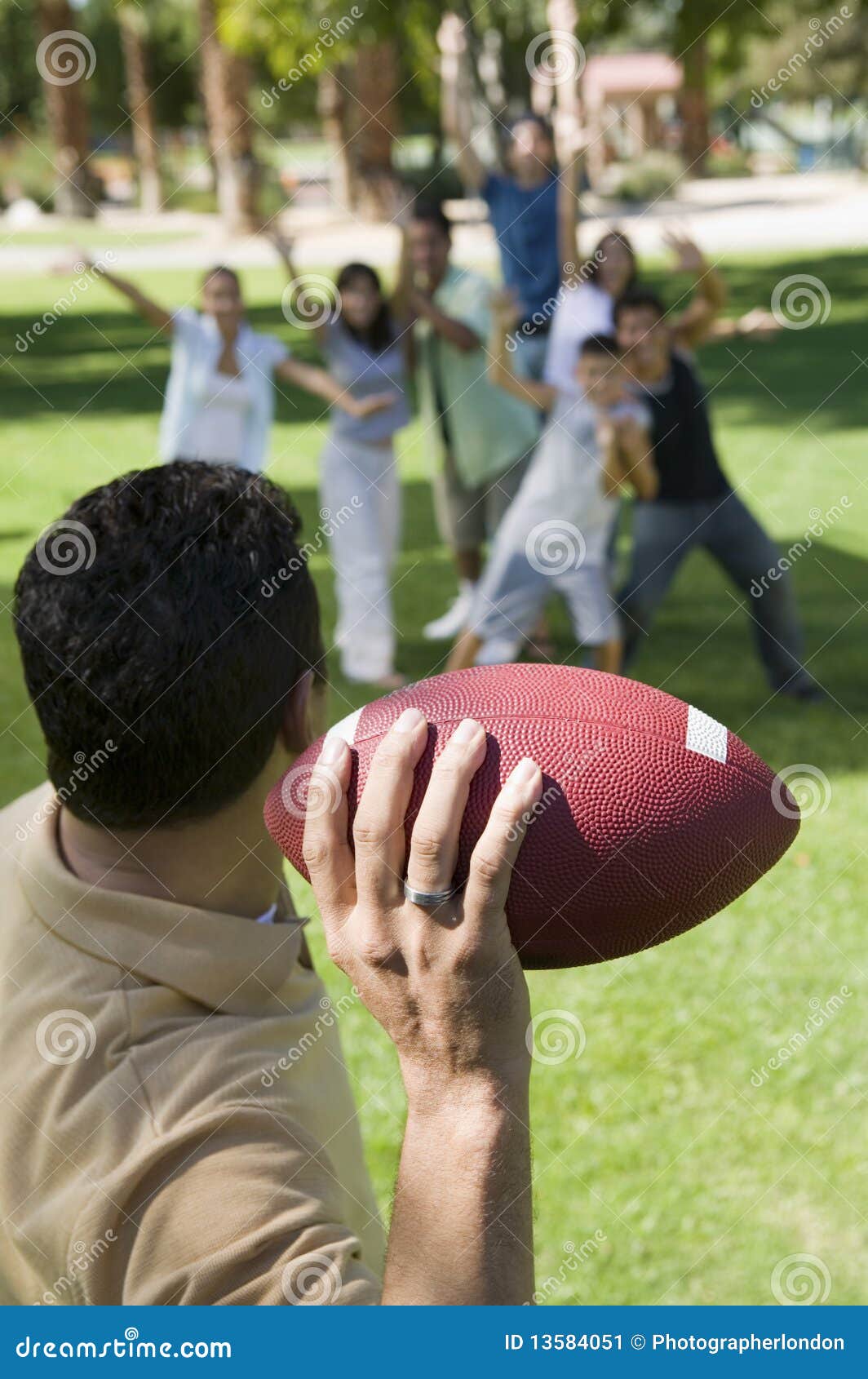 Man Throwing Football To Group Stock Image Image of outdoors, range