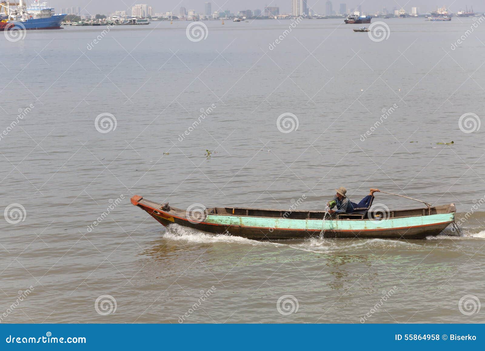 Man Throwing Out Water from His Boat on the Saigon River Editorial