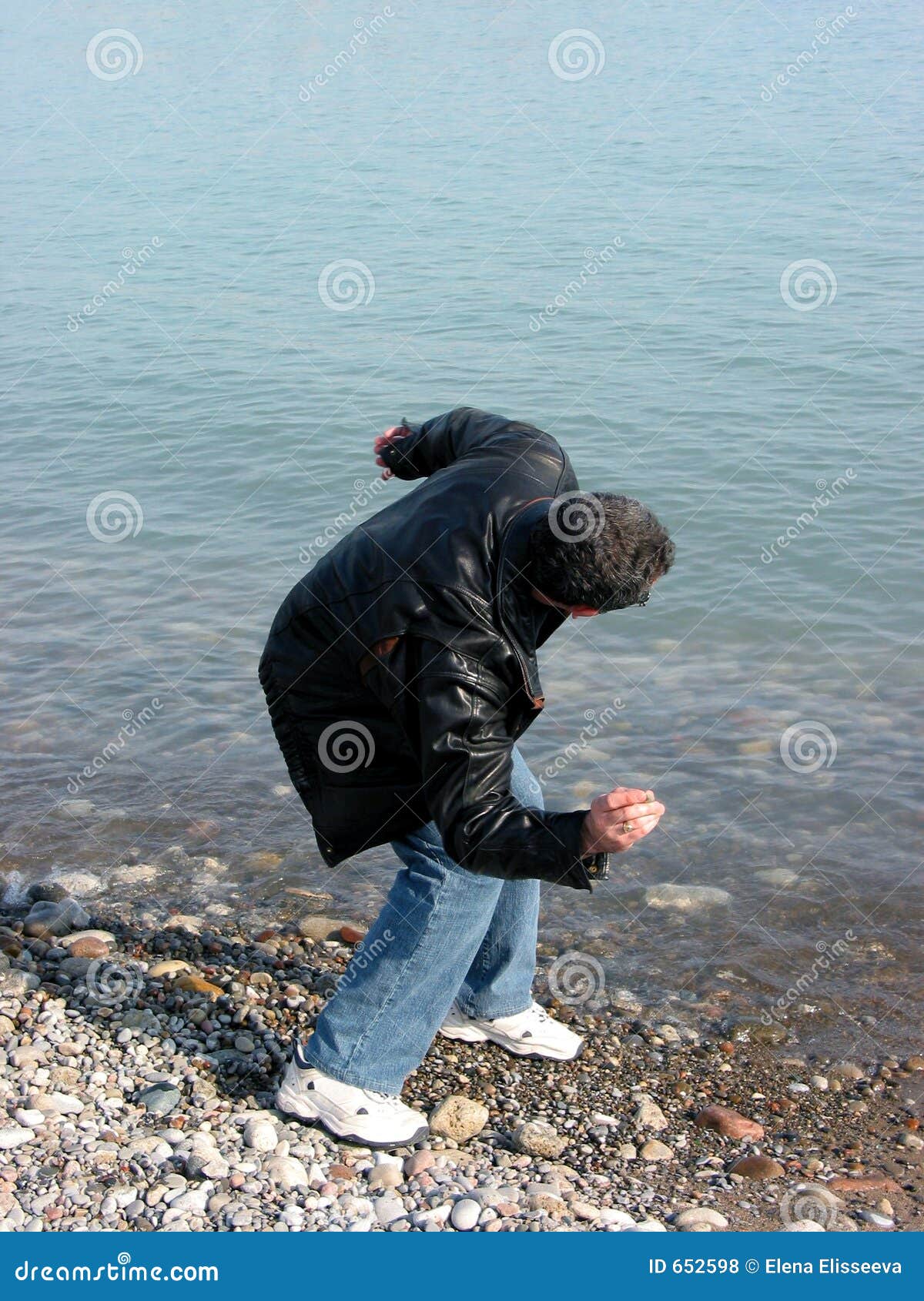 Man throwing pebbles stock photo. Image of people, blue 652598