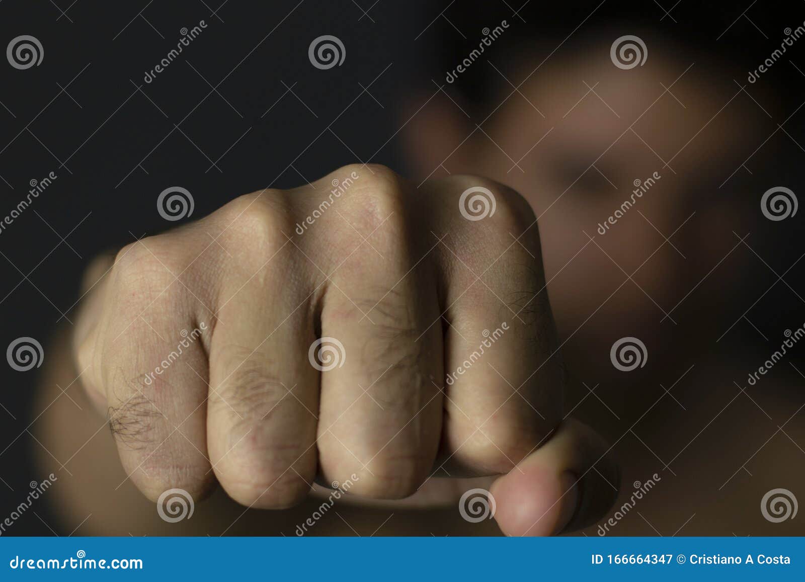man throwing punch with blurred background
