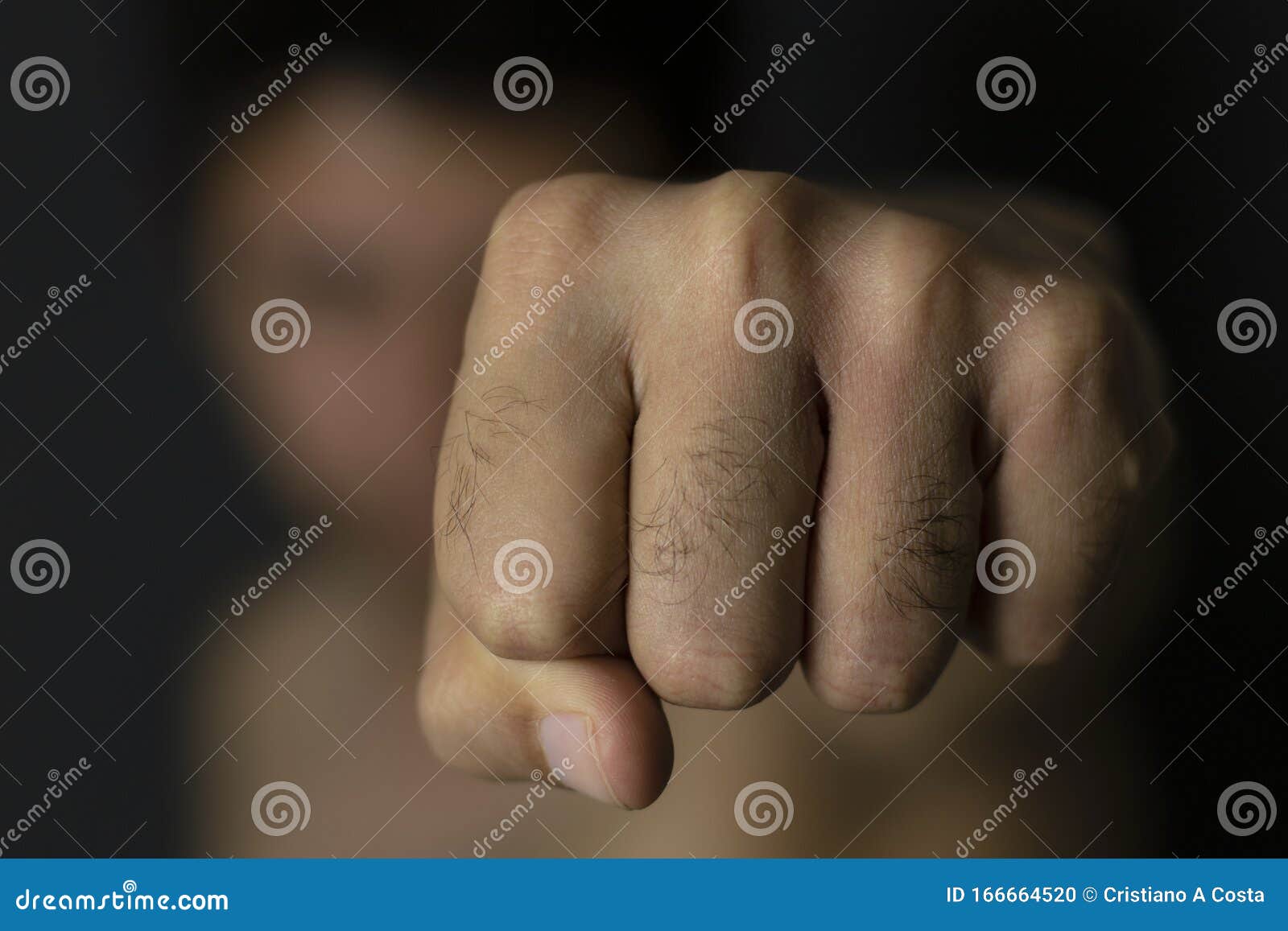 man throwing punch with blurred background