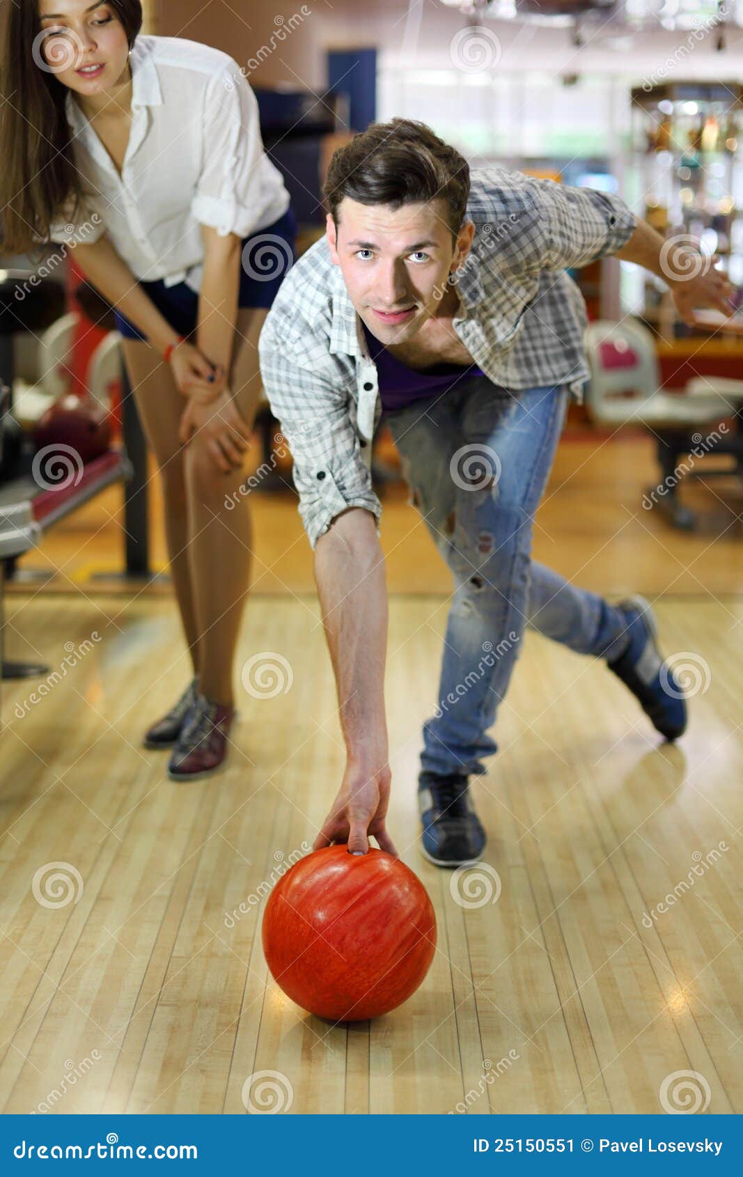 Man Throws Ball in Bowling; Woman Looks at Man Stock Image Image of
