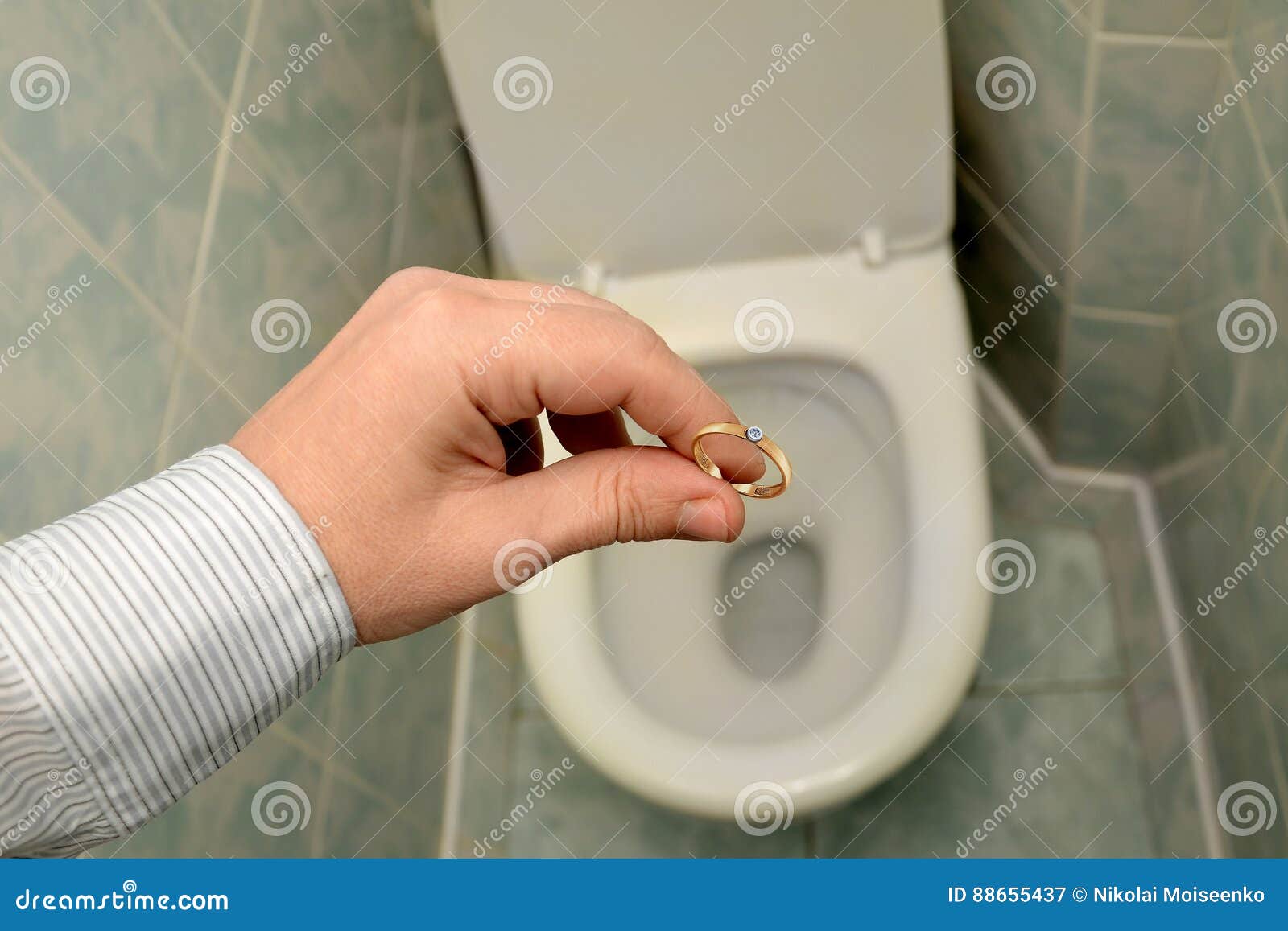 Man Throws a Wedding Ring into the Toilet.Divorce,end of Love. Stock