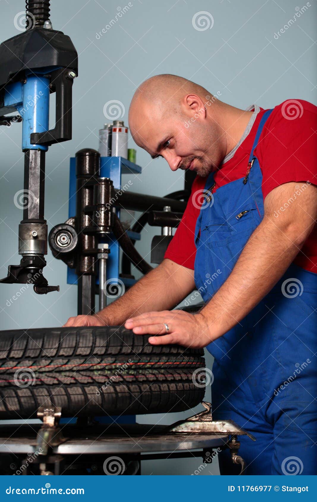 Man with a tire stock image. Image of professional, equipment 11766977