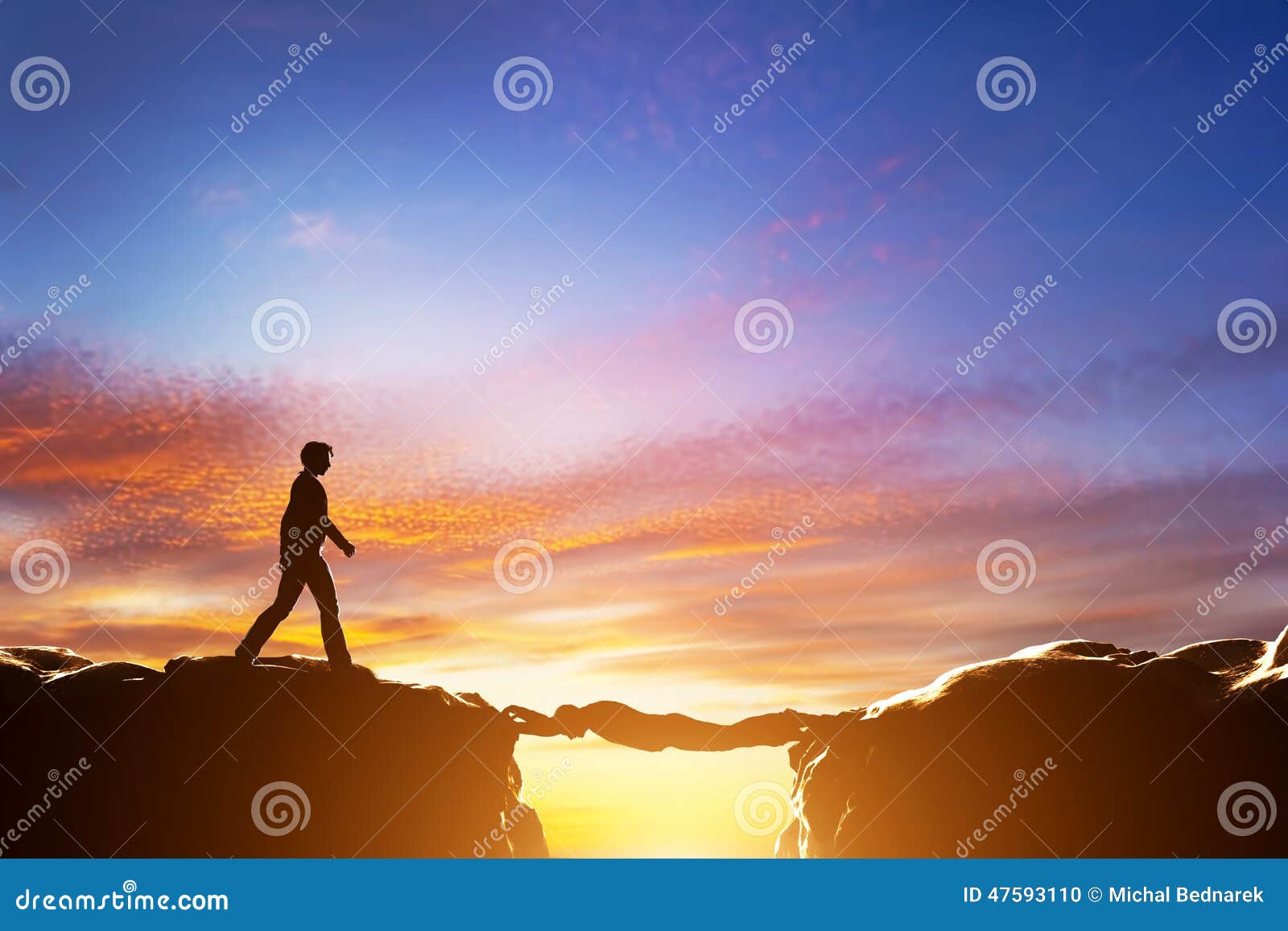 man about to croos precipice between mountains over another man
