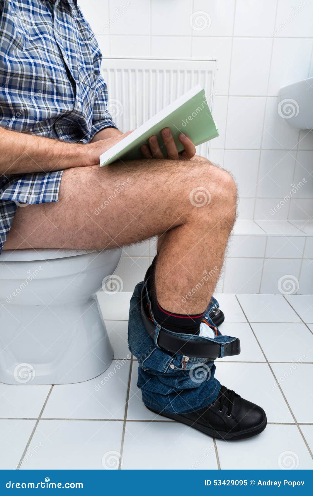 Man With Newspaper Sitting On Toilet Bowl Stock Image 