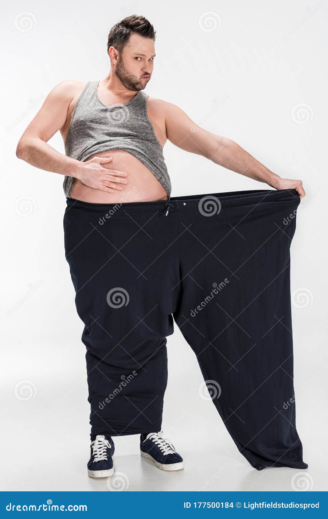 Woman holding huge pants — Stock Photo © alanpoulson #13746100
