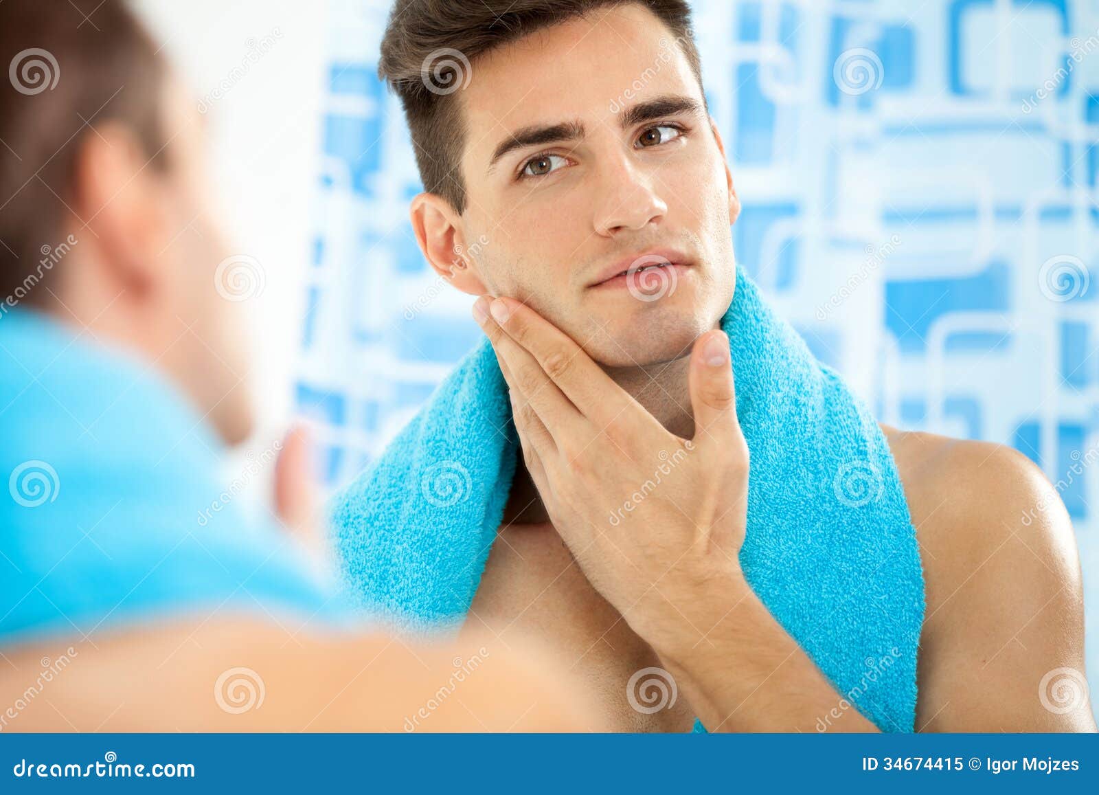 man touching his face after shaving