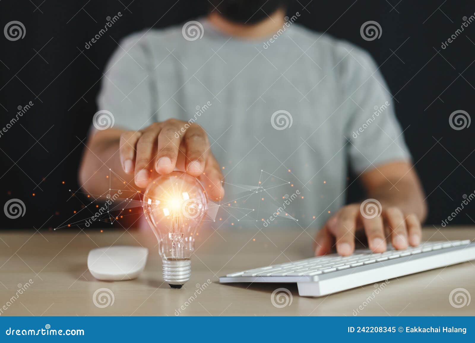 Man Touching Light Bulbs Using Computer Keyboard. Creative Innovation