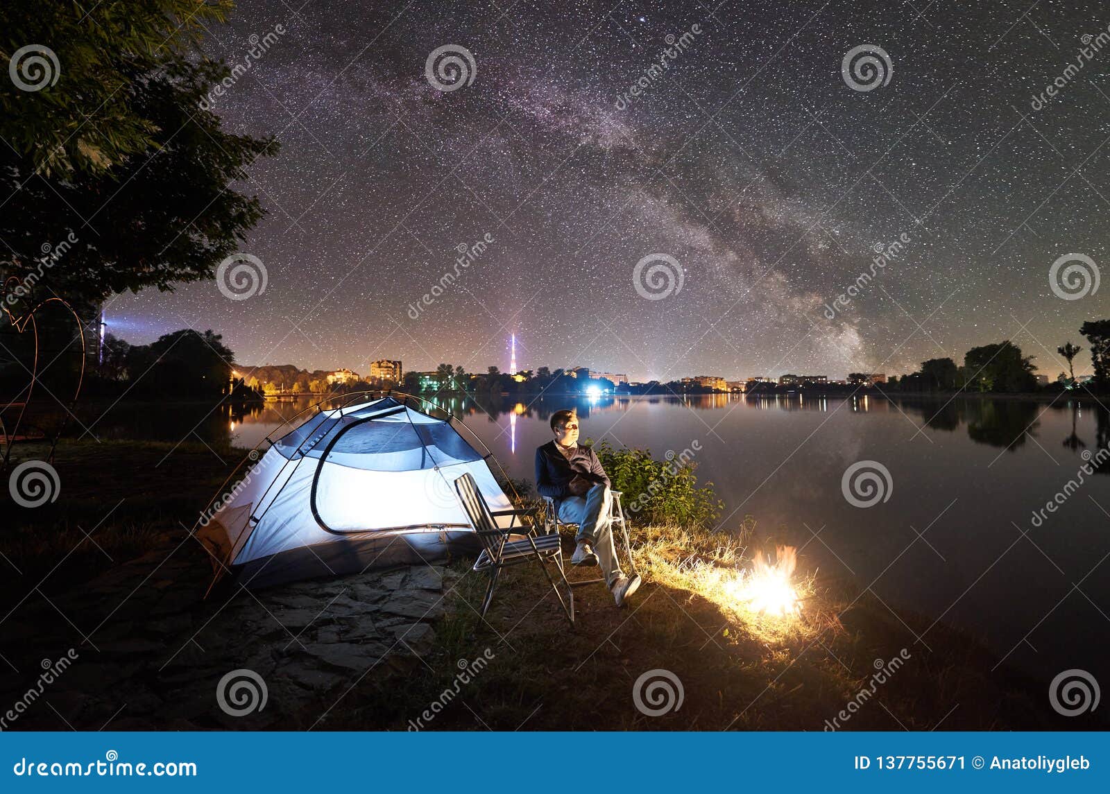 Man Tourist Resting Sitting On Chair On Lake Shore At Night