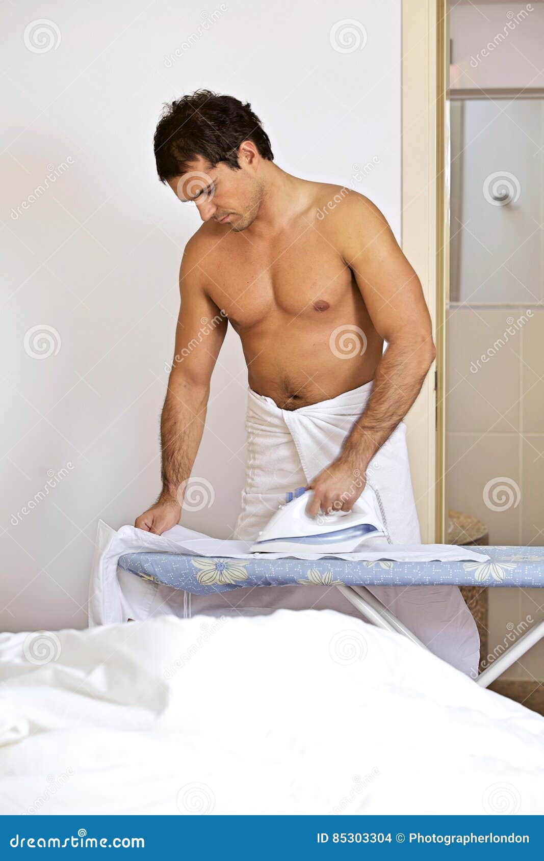 Man in Towel Ironing Clothes on a Stand Stock Photo Image of adult
