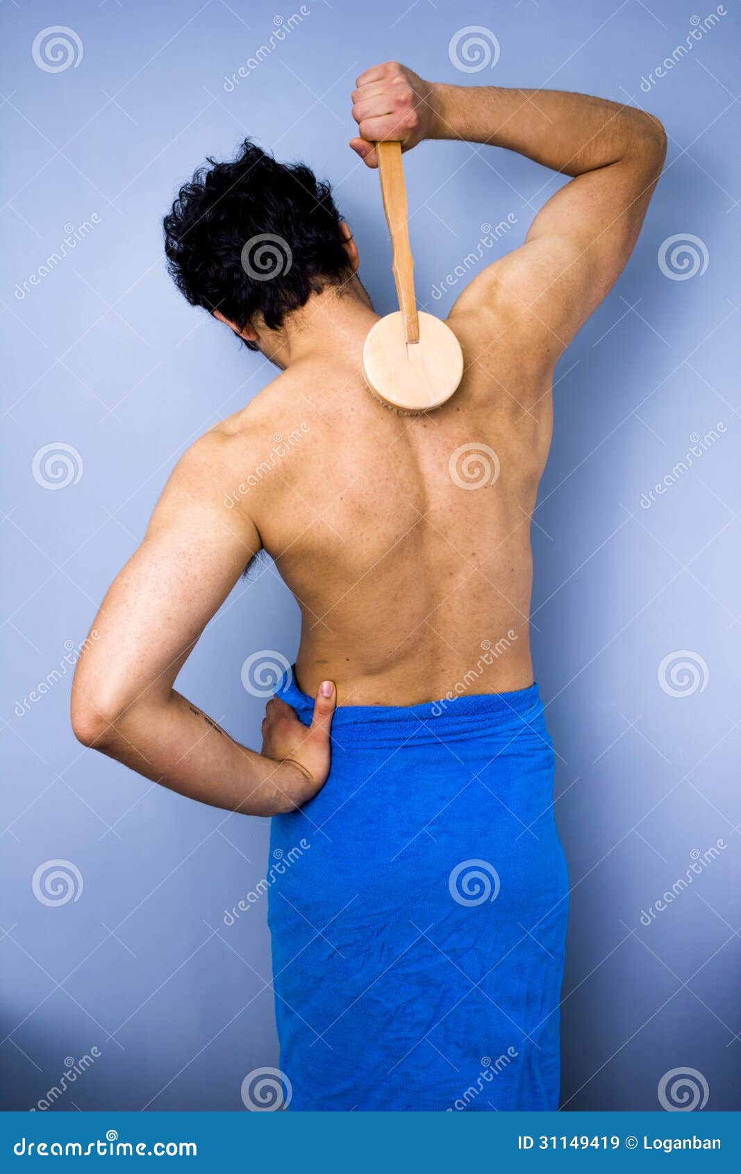 man in towel scrubbing his back