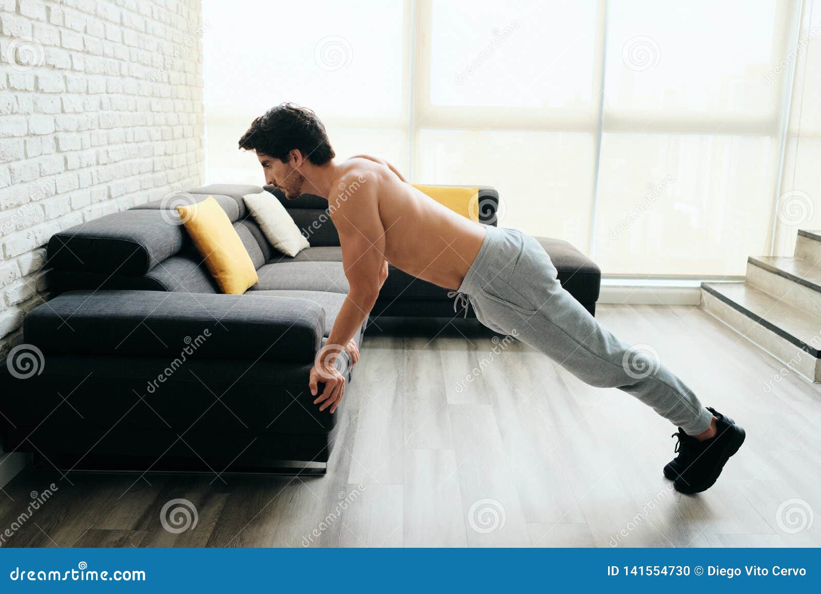Man Training Chest and Biceps Doing PushUps with Backward Grip Stock