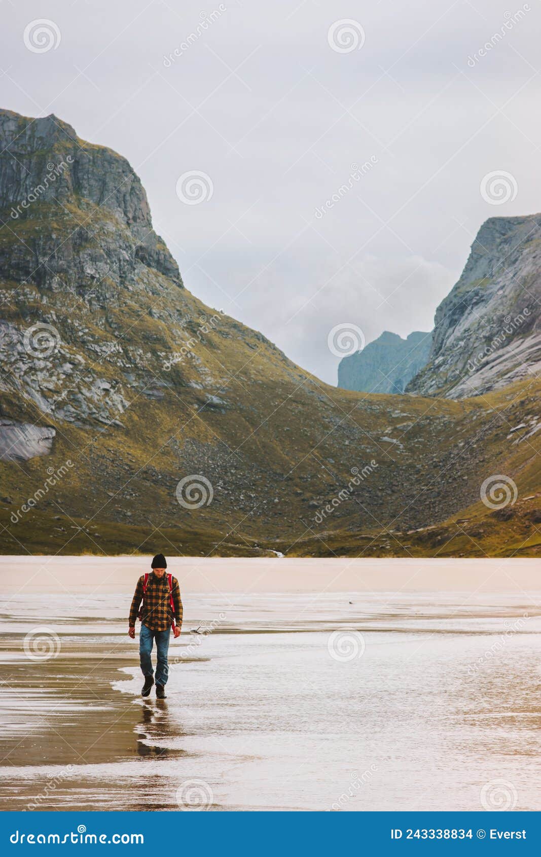 man traveling in norway hiking outdoor active healthy lifestyle walking on sandy horseid beach