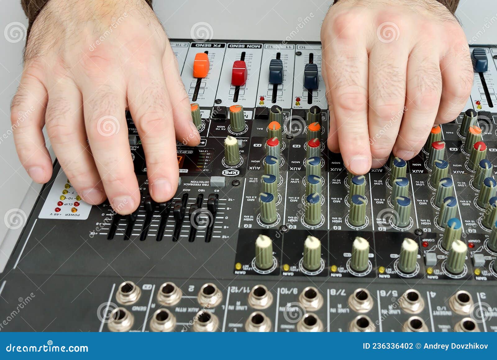 The Man Turns the Potentiometers and Adjusts the Equalizer in Front of ...