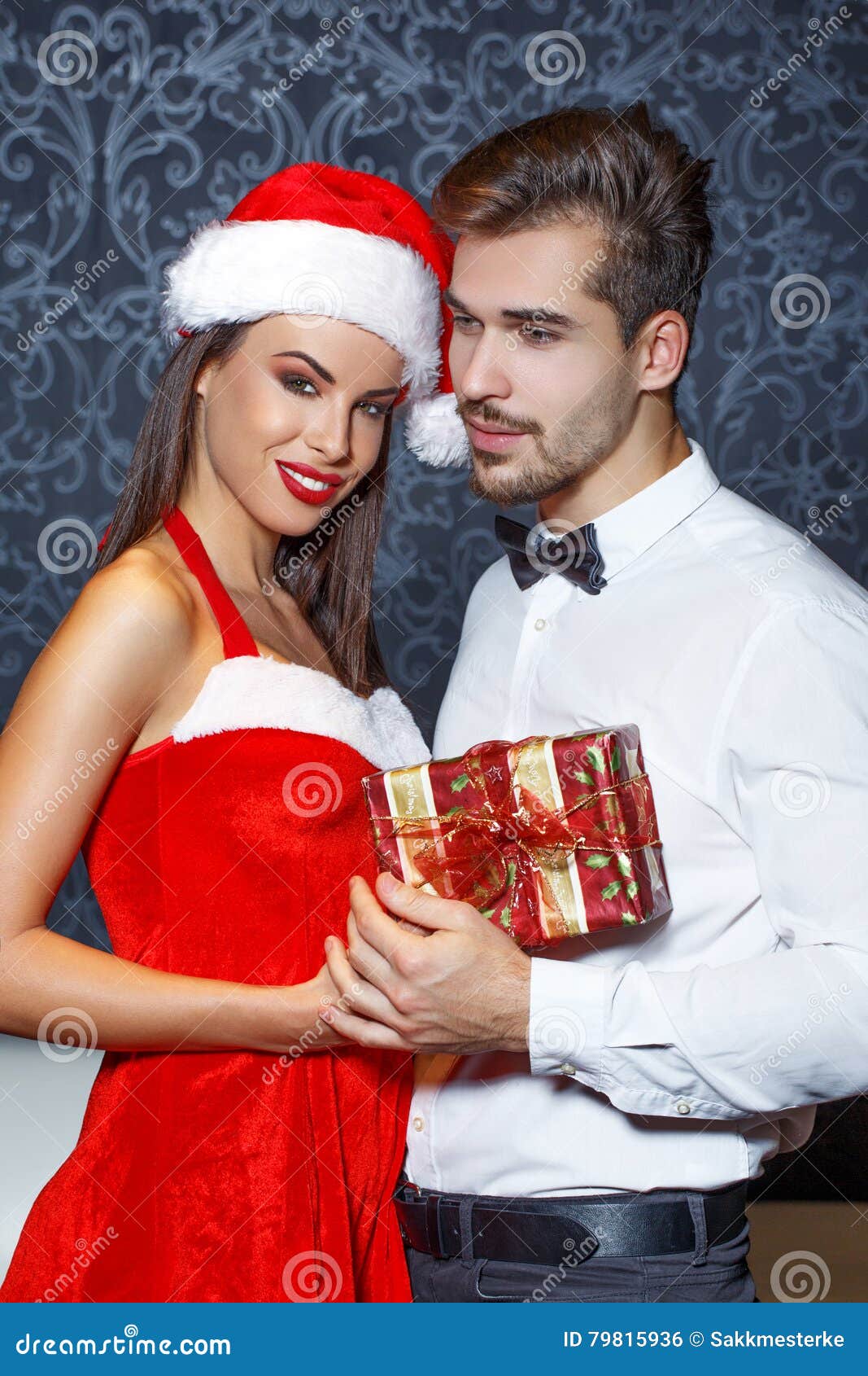 man in tux get christmas present from girlfriend